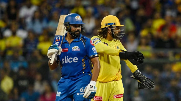 MI vs CSK players in action on the field, featuring a Mumbai Indians batsman and Chennai Super Kings wicketkeeper during an IPL match.